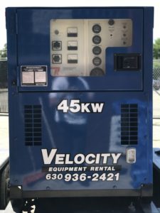 A blue generator sitting on a trailer