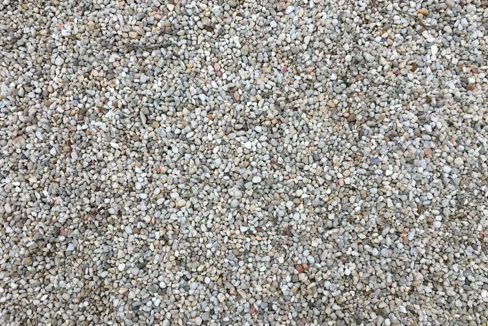 Close-up of beige pea gravel texture